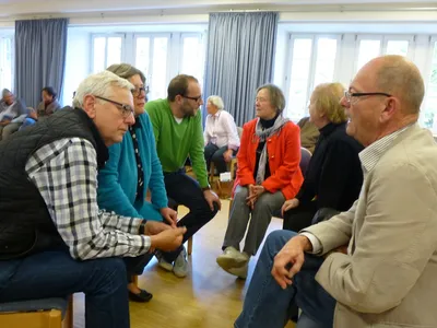 ältere Menschen im Gespräch sitzend im Kreis