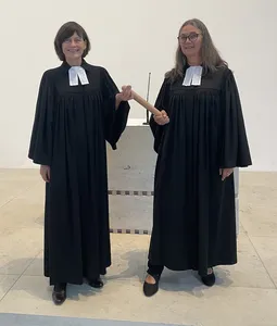 Quelle: Michael Streib Pfrin Sabine Kast-Streib seht zusammen mit Pfrin. Judith Winkelmann vor dem Altar. Zwischen Ihnen der Stab den beide am jeweils anderen Ende festhalten.